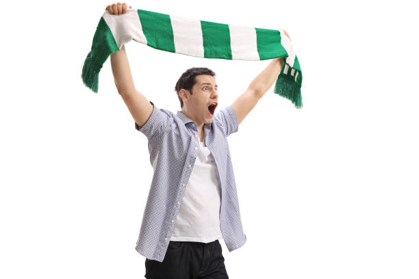 istock Ecstatic football fan holding a scarf and cheering 678618848