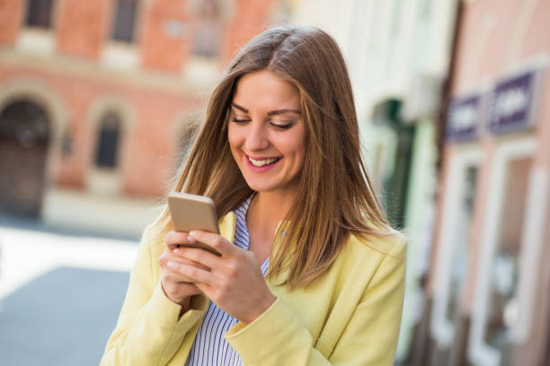 istock Woman using mobile phone outdoor 678627038
