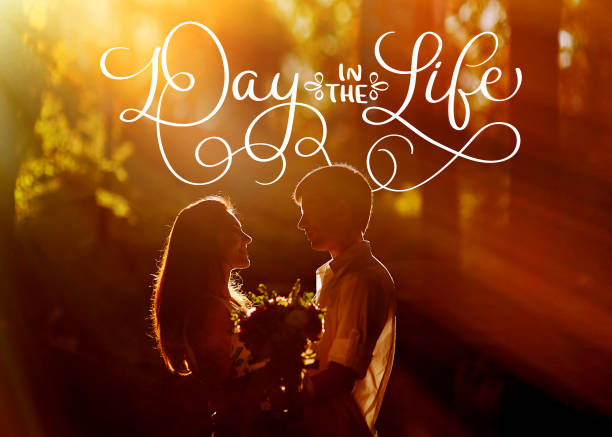 young loving couple kissing in the evening in the park and text day in the life. calligraphy lettering vintage hand draw - silhouette kissing park sunset imagens e fotografias de stock