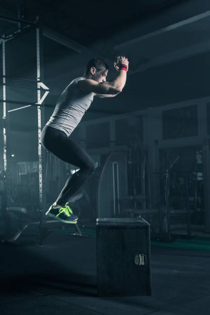 istock Determined male athlete doing box jumping at gym 678650850