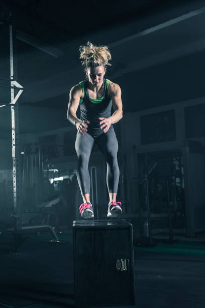 istock Woman doing box jumps at gym 678651554