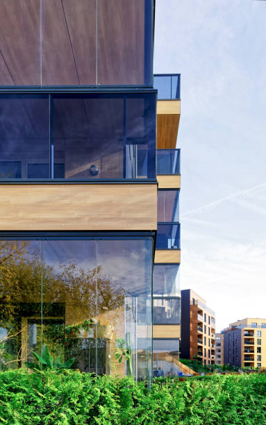 istock Modern glass apartment building and Birch trees 678679352