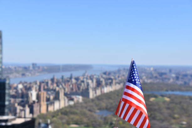 istock US flag against the background of Central Park 678689974
