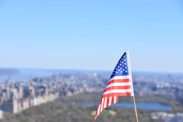 istock US flag against the background of Central Park 678689980