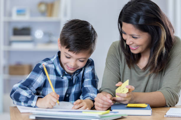 istock Confident mom teaches son at home 678696794