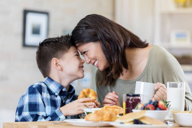 istock Mom and son enjoy breakfast together 678696840