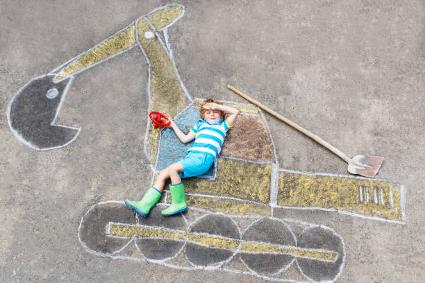 istock Funny little kid boy with excavator chalk picture 678696868