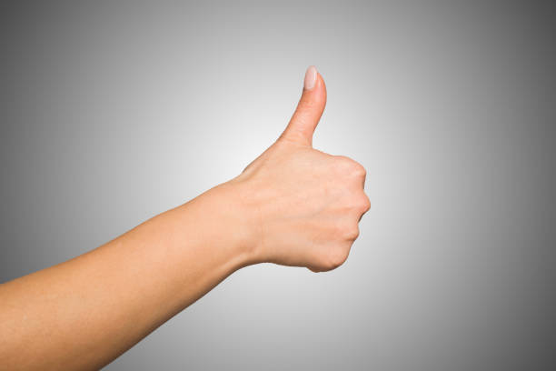Close-up of a female hand giving thumbs up