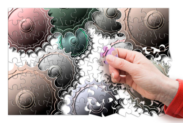 istock Female hand disassemble and assemble a gear - concept image in puzzle shape 678698126