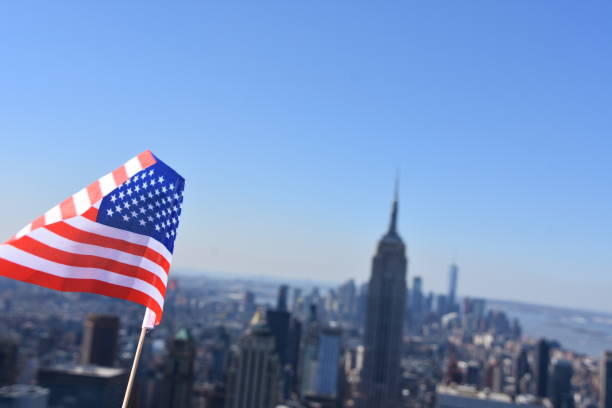 istock US flag against the background of Empire State Building 678698976