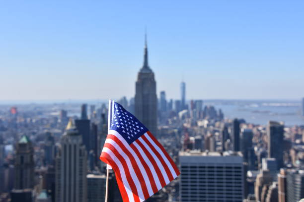 istock US flag against the background of Empire State Building 678699414