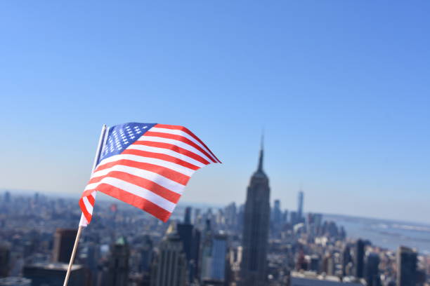 istock US flag against the background of Empire State Building 678699420