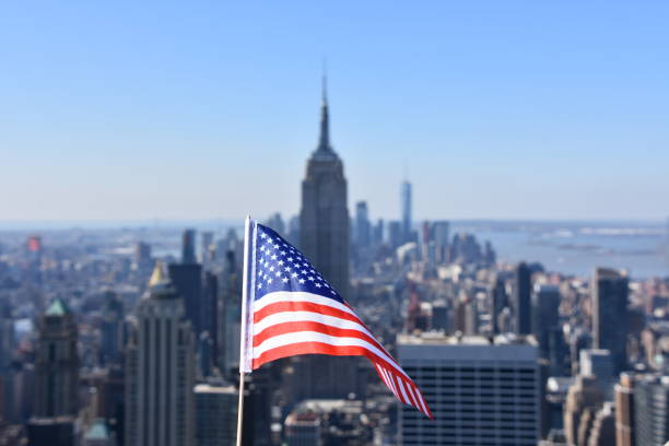 istock US flag against the background of Empire State Building 678699608
