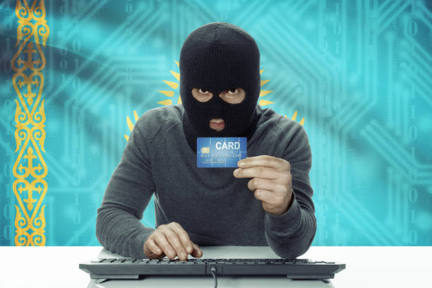 istock Dark-skinned hacker with flag on background holding credit card - Kazakhstan 678700012