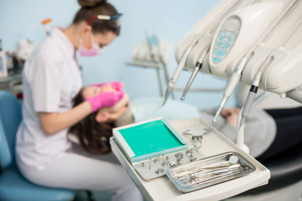 istock Different professional dental instruments, on the blurred background dentist is treating patient in dental clinic. Selective focus. Dentistry 678701134