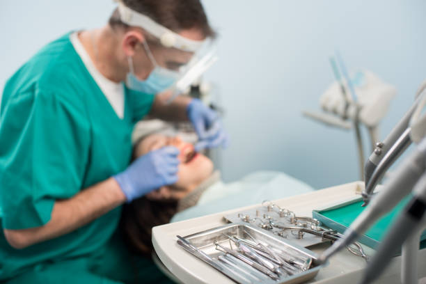 istock Different professional dental devices, on the blurred background dentist is treating patient in dental office. Selective focus. Dentistry 678701320