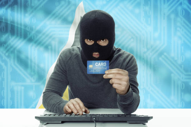 istock Dark-skinned hacker with flag on background holding credit card - Saint Lucia 678718880