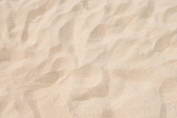 夏のビーチの砂のパターンのクローズアップ - beach ストックフォトと画像