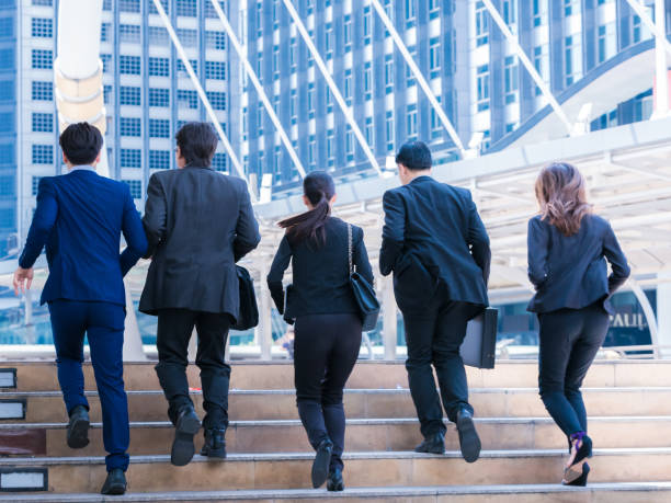 istock Group Business people running in city 678728548