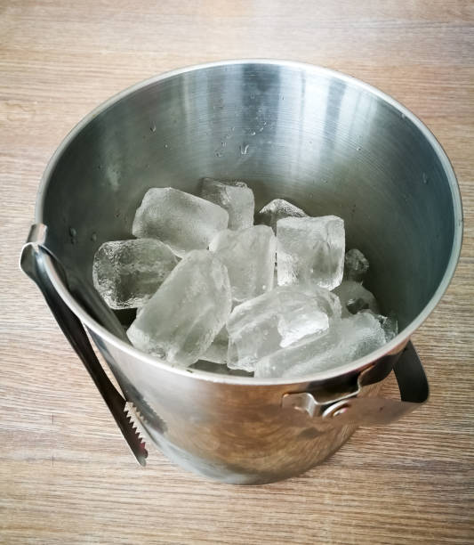 istock Ice bucket on wooden table 678735954