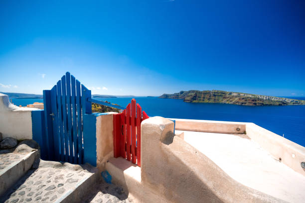 Traditional symmetric doors yard, Ia, Santorini, Greece. Honeymoon summer aegean cycladic background, serenity, tranquility.
