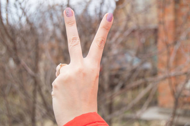 istock Women's left hand shows the victory sign 678750042
