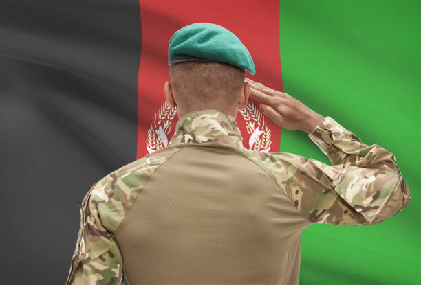 istock Dark-skinned soldier with flag on background - Afghanistan 678751850