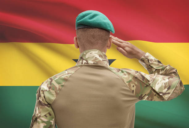 istock Dark-skinned soldier with flag on background - Ghana 678752816