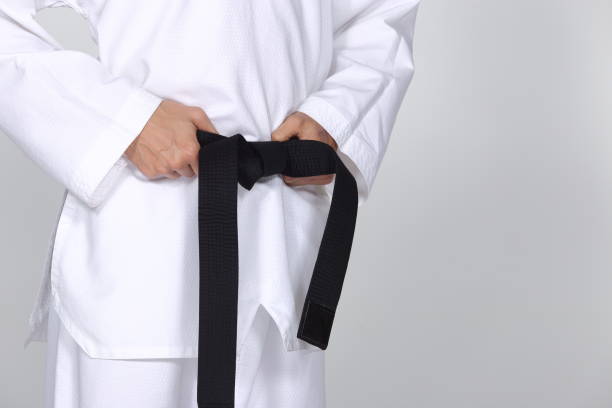 istock Master Black Belt TaeKwonDo Teacher hold  and tie belt pose 678752966