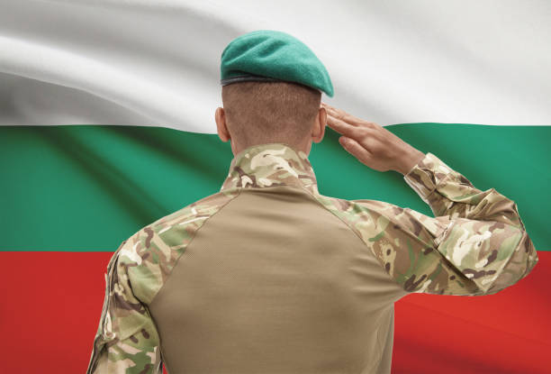 Dark-skinned soldier with flag on background - Bulgaria stock photo