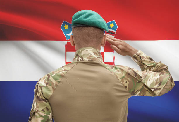 istock Dark-skinned soldier with flag on background - Croatia 678754372