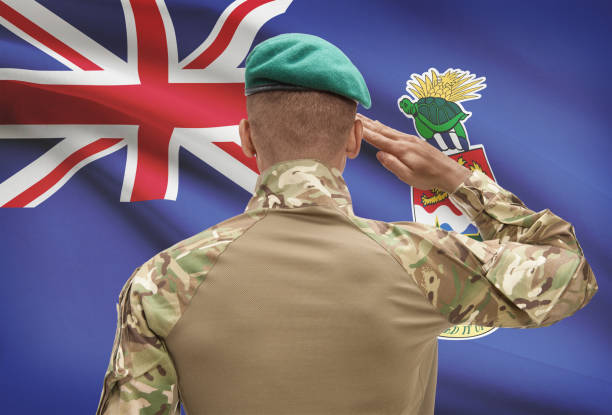 istock Dark-skinned soldier with flag on background - Cayman Islands 678754604