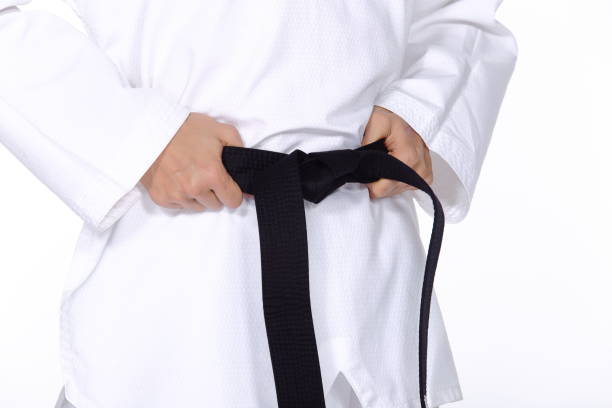 istock Master Black Belt TaeKwonDo Teacher hold  and tie belt pose 678754872