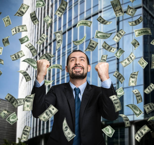 istock Businessman under a money rain 678757550