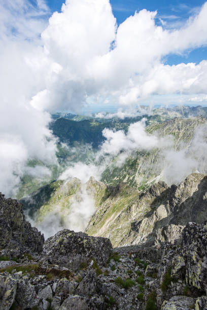 istock rocky mountain landscape covered with clouds 678774306