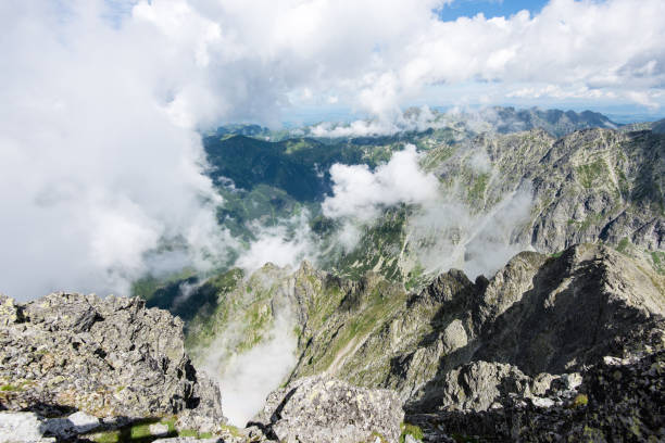 istock rocky mountain landscape covered with clouds 678774310