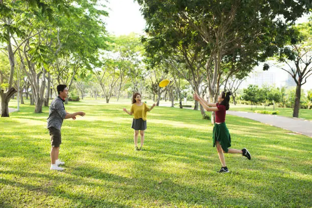 Group of friends playing frisbee in the park