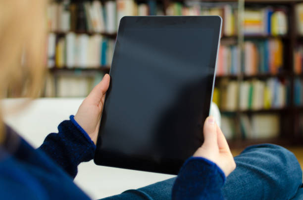 istock Woman looking at blank digital tablet computer with copy space 678787126