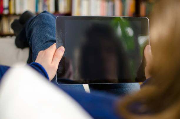 istock Woman looking at blank digital tablet computer with copy space 678787206