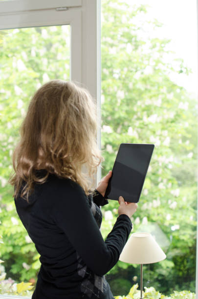 istock Woman looking at blank digital tablet computer with copy space 678787810