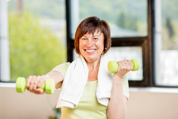 istock Older woman exercising indoors 678797418