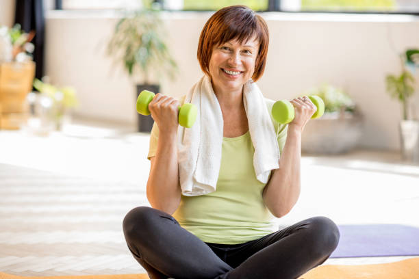 istock Older woman doing yoga indoors 678798974