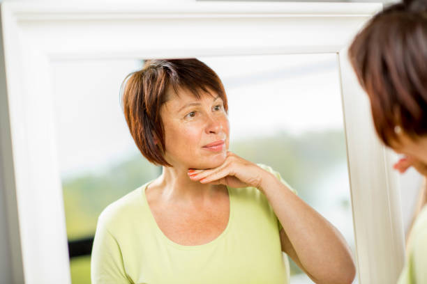 istock Older woman looking into the mirror 678812750