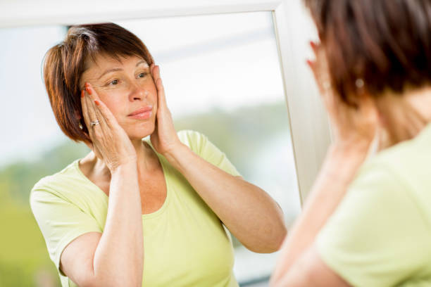 istock Older woman looking into the mirror 678812856