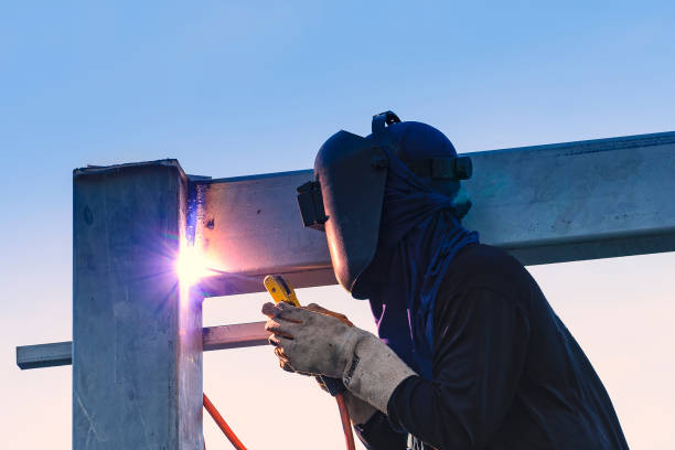 Worker welding parts of stell construction