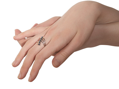 Female hand with a ring on a white background
