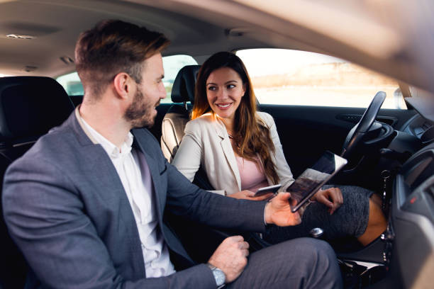 istock Business couple using digital tablet in the car 678823438
