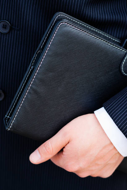istock Businessman holding a day planner 678823478