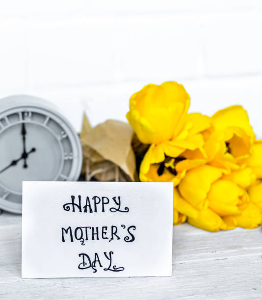 istock bouquet of yellow tulips and a retro clock 678826552