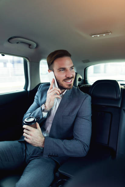 istock Successful businessman in a car using mobile phone. 678826876